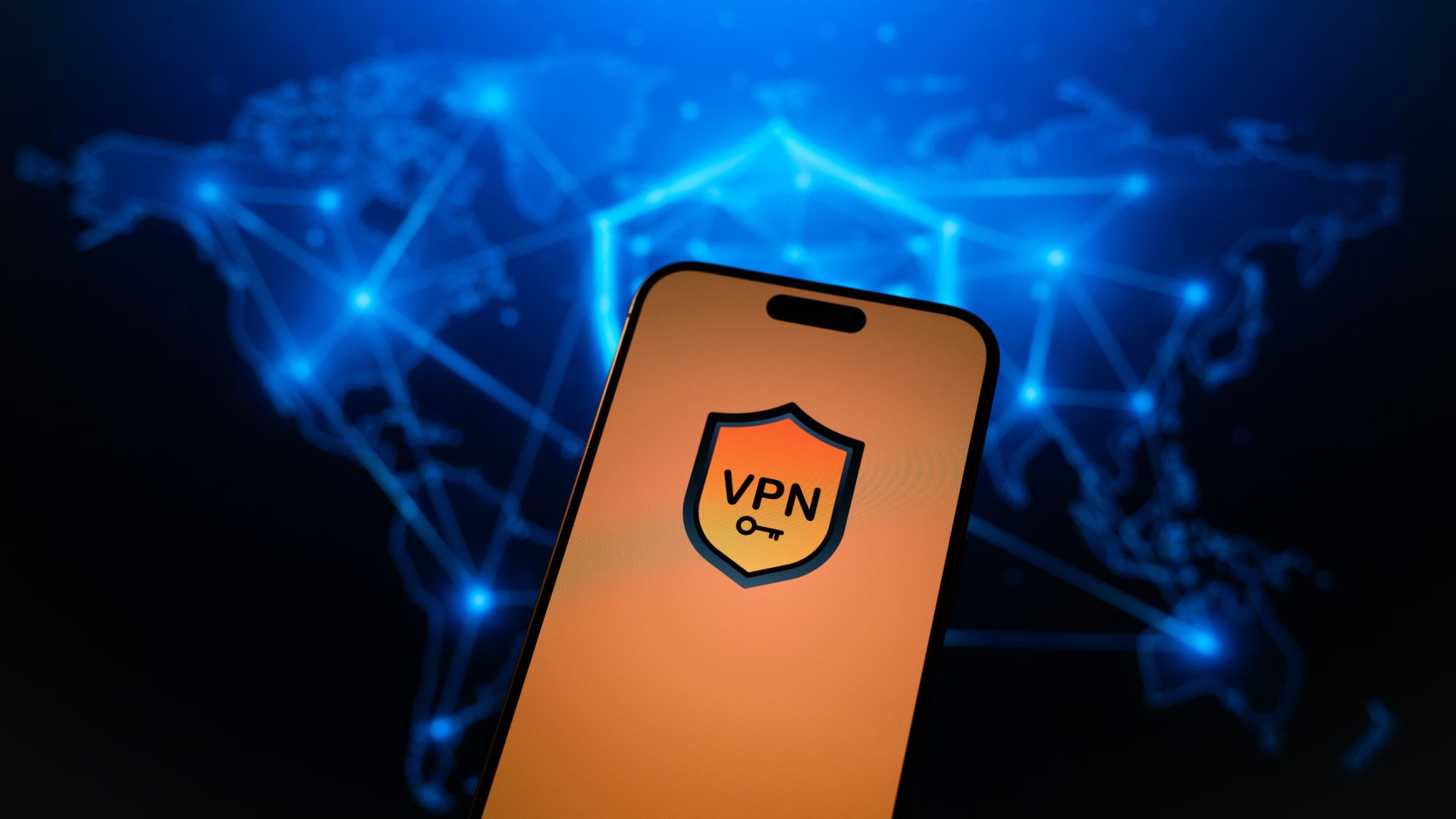 A mobile phone with a generic VPN screen and a world map of the server network in the background.