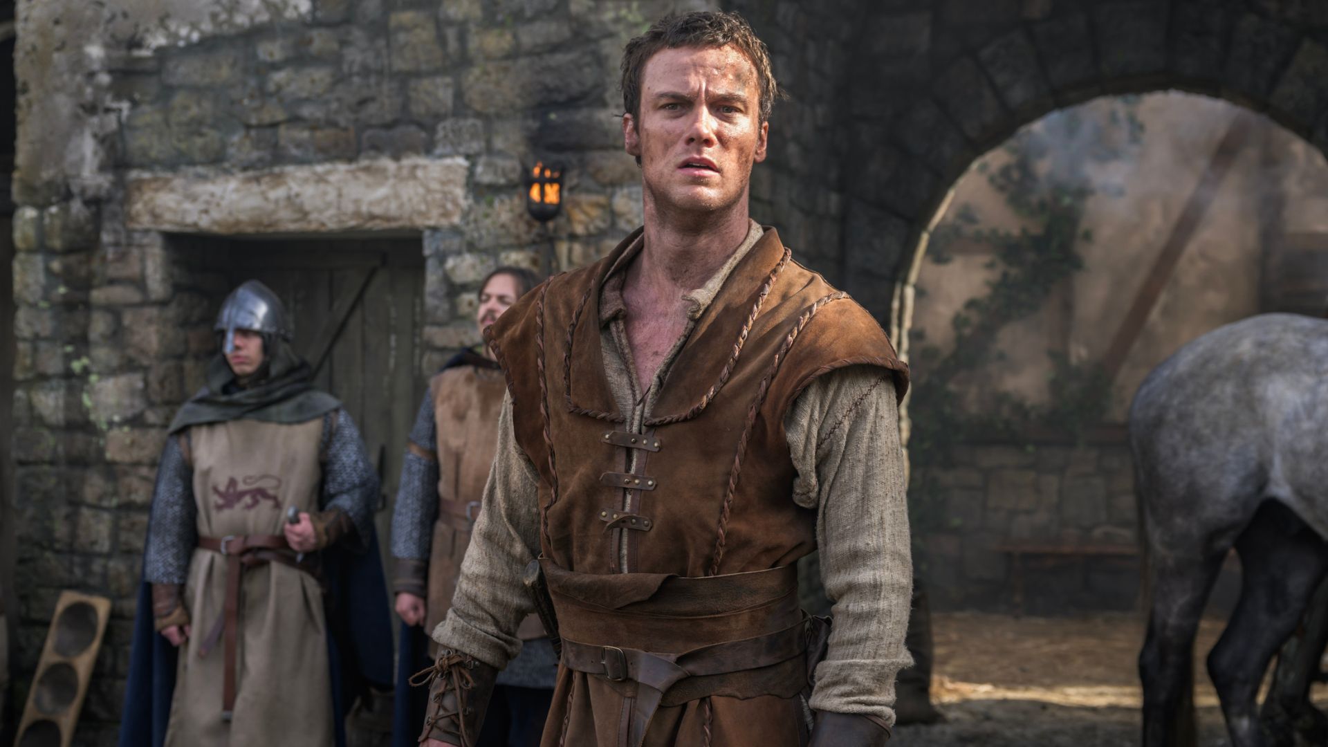 A dirt-covered Robin Hood stares into the distance