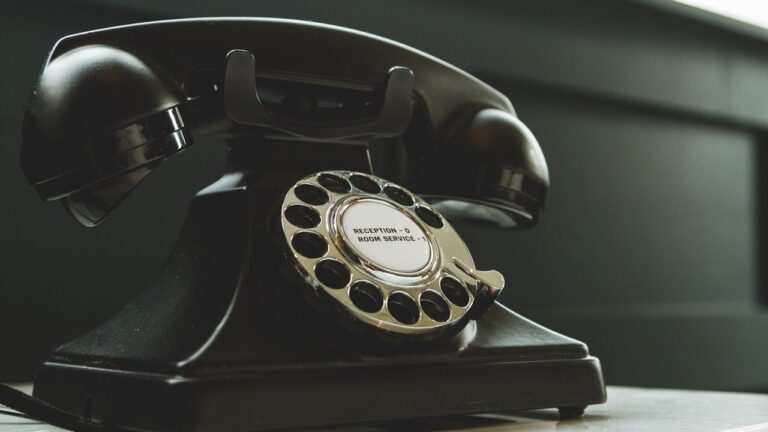 Black Rotary Telephone on White Surface