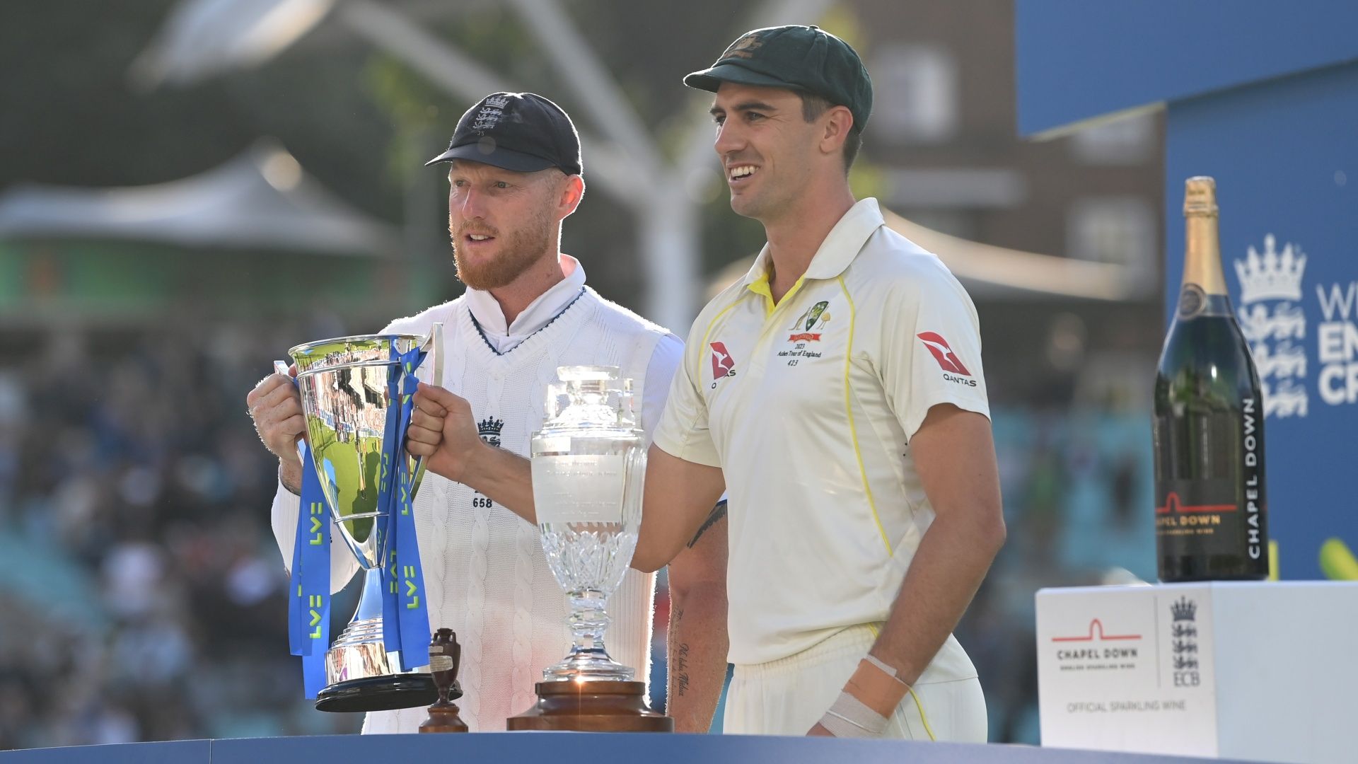 England captain Ben Stokes and Australia captain Pat Cummins posing with the shared Ashes trophies