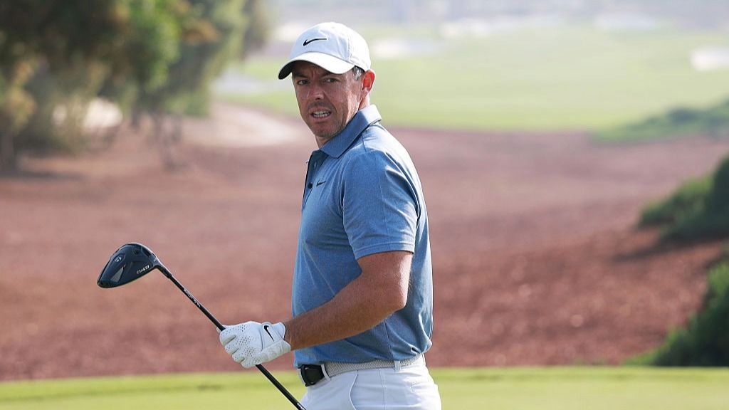 Golfer Rory McIlroy of Northern Ireland, holding a driver, walks off a hold at the Abu Dhabi HSBC Championship 2025 tournament