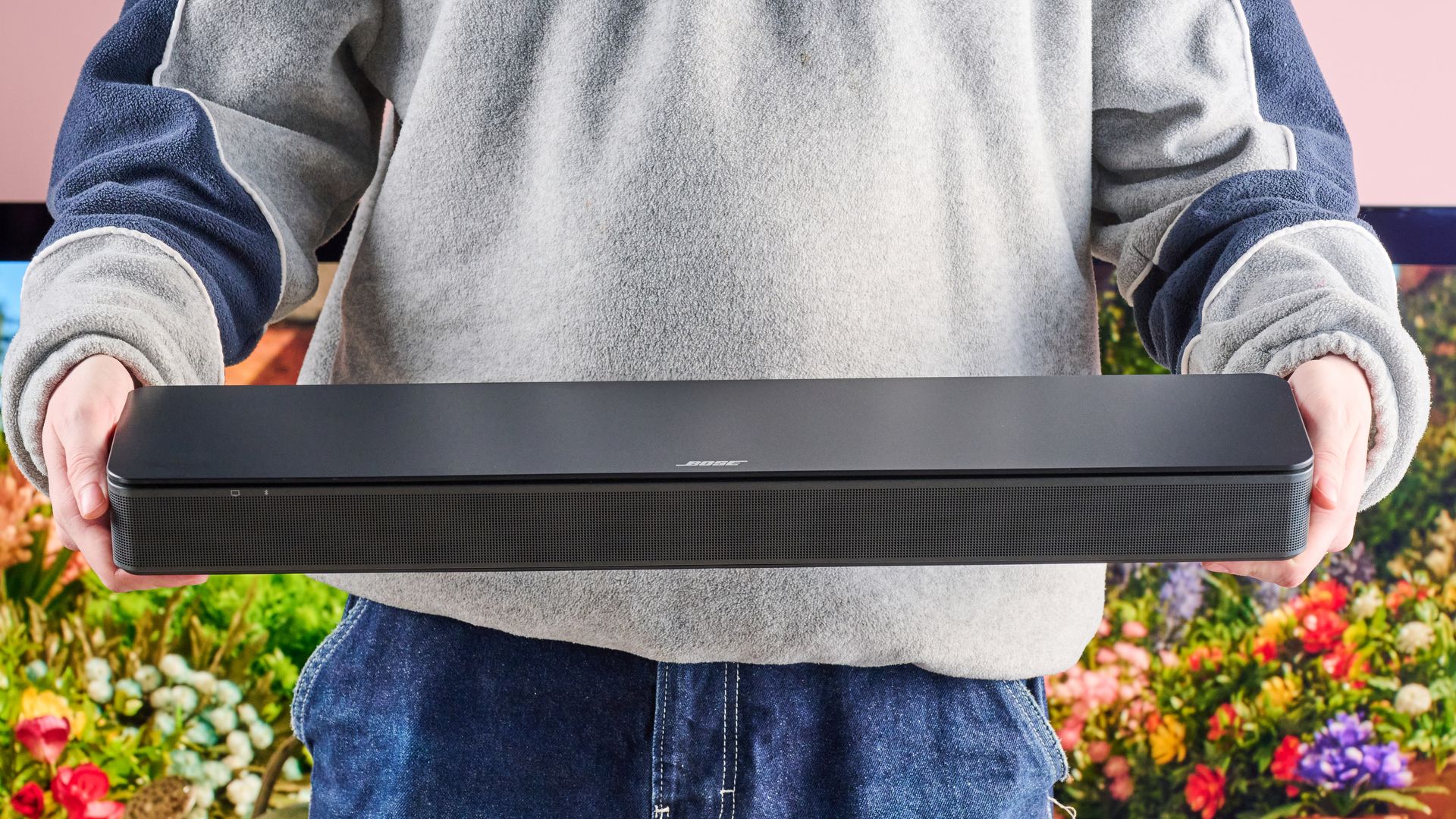 Man holding the Bose TV Speaker