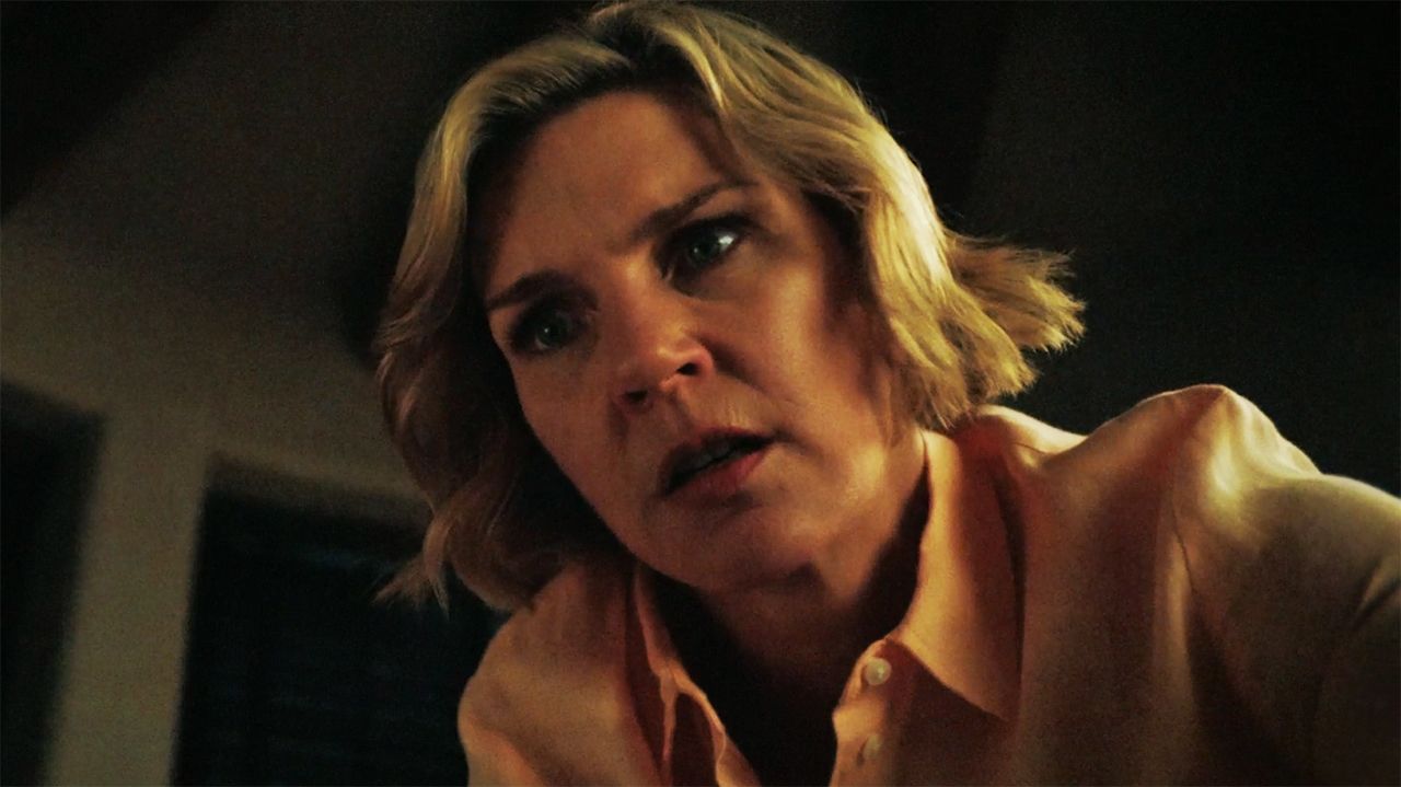 A concerned Carol looking down at an off-camera Zosia in Pluribus episode 9