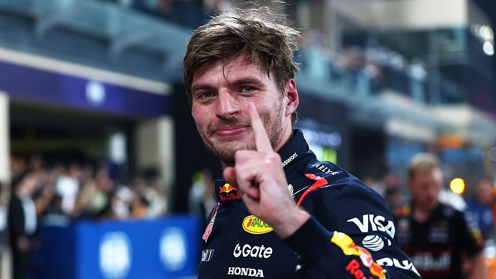 Max Verstappen of Red Bull raises his finger to indicate the number one after qualifying on pole position at the 2025 Abu Dhabi Grand Prix.
