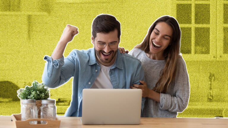Young couple looking excited at a laptop