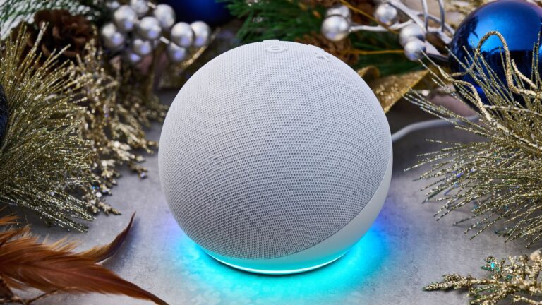 An Amazon Echo Dot is surrounded by a festive garland.