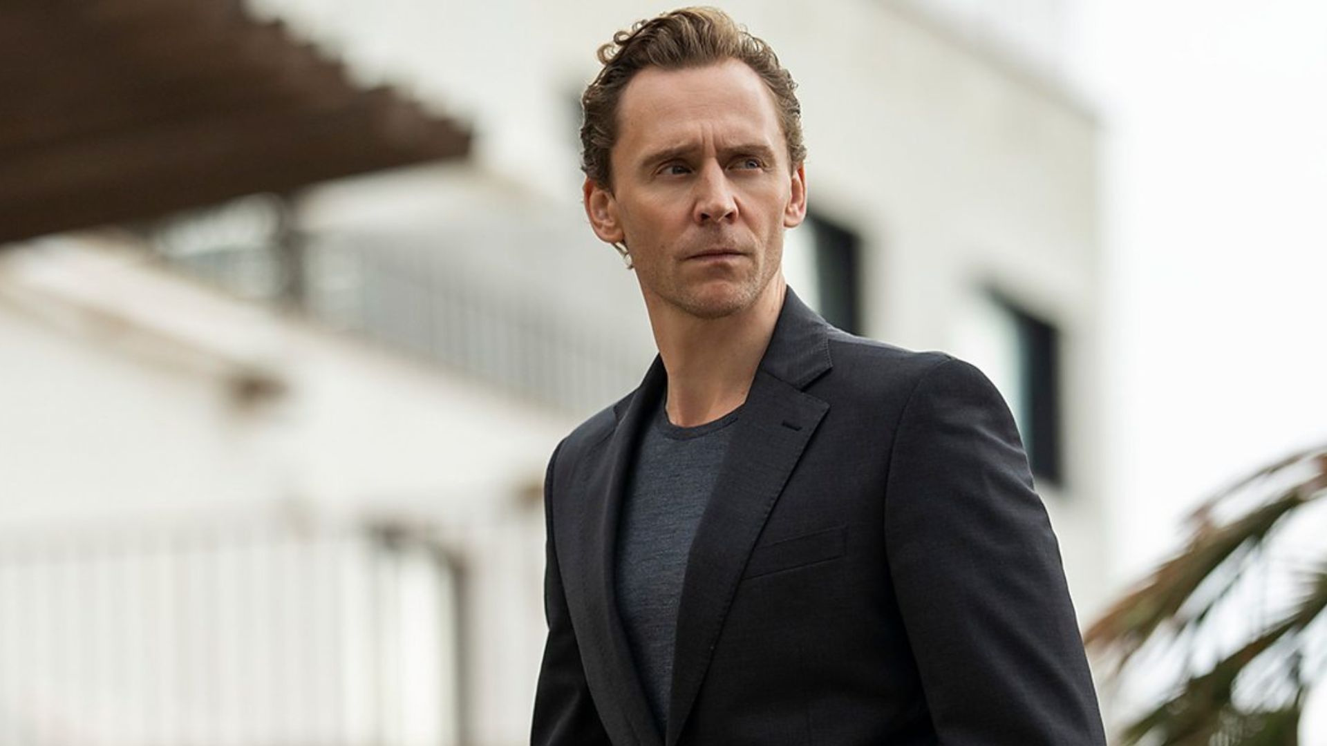 Tom Hiddleston looks at something off camera