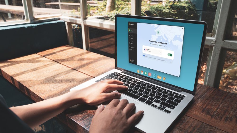 A person using a laptop with Norton VPN activated.