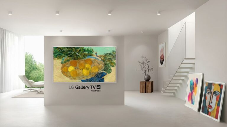 LG Gallery TV in an expensive-looking white room with paintings resting against one wall 