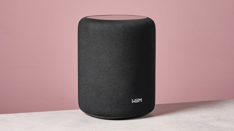 The WiiM Sound Lite at a 45 degree angle in front of a pink background.