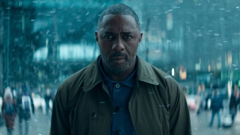 Idris Elba stands in the snow 