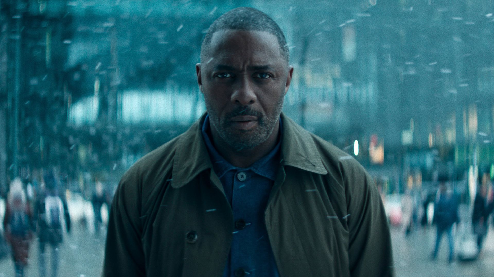 Idris Elba stands in the snow