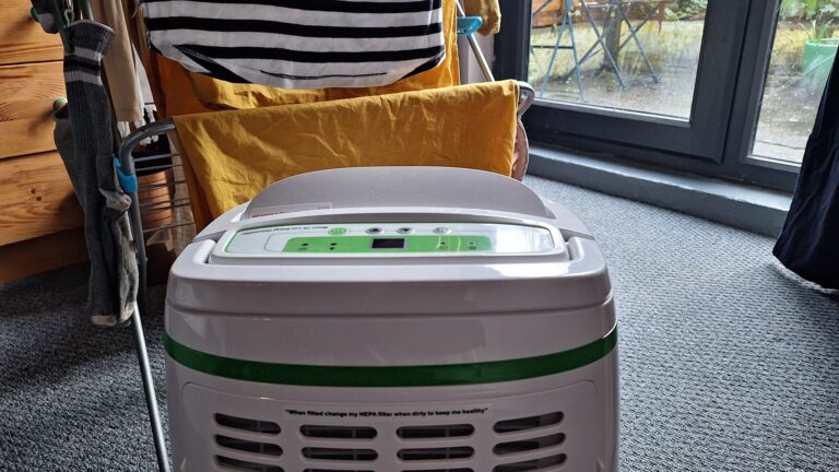 Meaco 12L Low Energy Dehumidifier in front of a rack of drying clothes