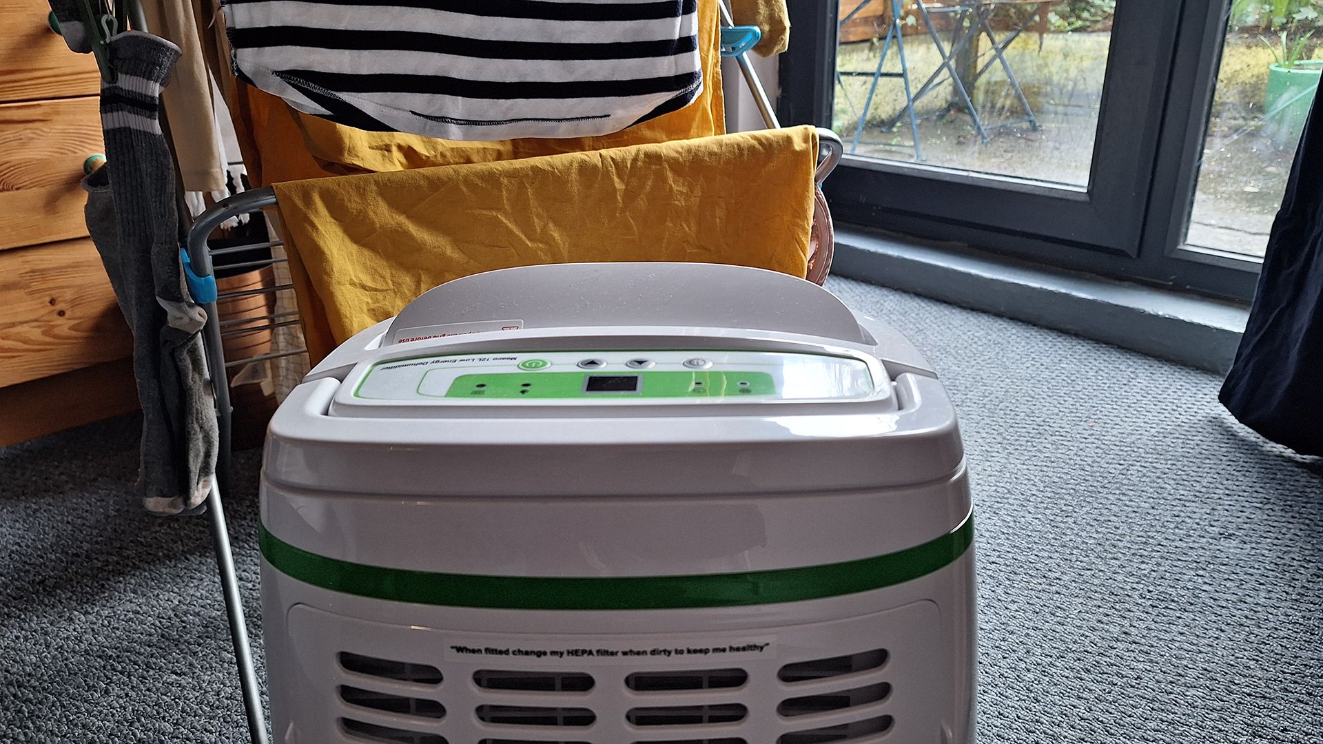 Meaco 12L Low Energy Dehumidifier in front of a rack of drying clothes