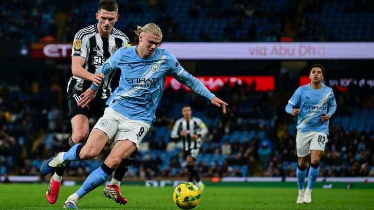 Erling Haaland of Man City shields the ball from Sven Botman of Newcastle.