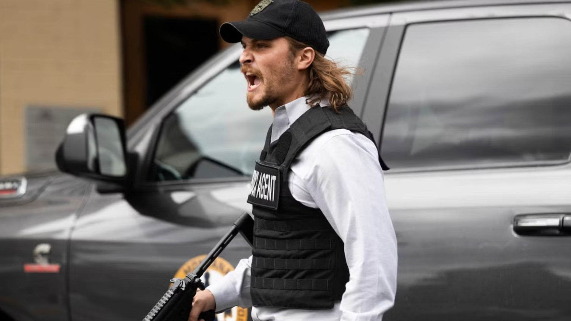 Kayce Dutton shouts while holding a gun