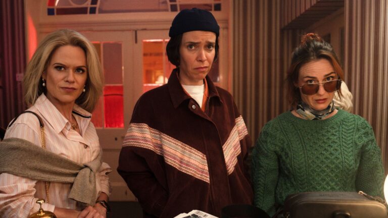 Robyn. Dara, and Saoirse stand at a hotel reception