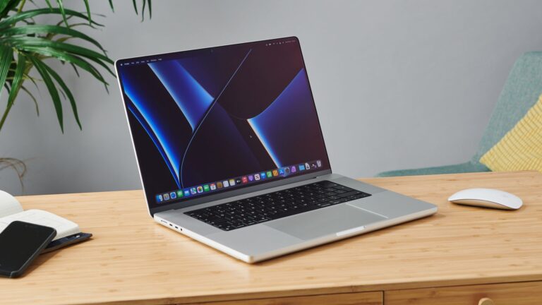 MacBook Pro 16-inch on wooden table in modern office