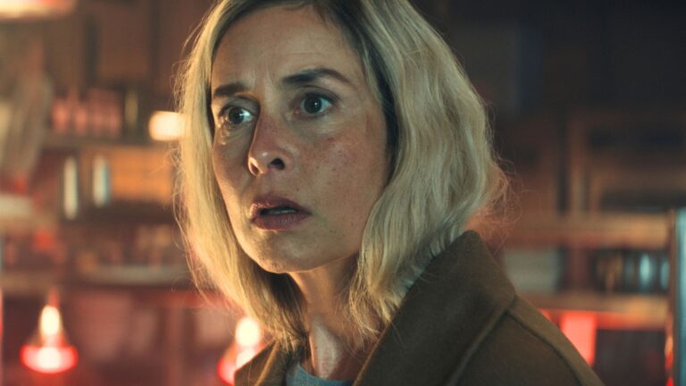 A woman looks shocked at something offscreen