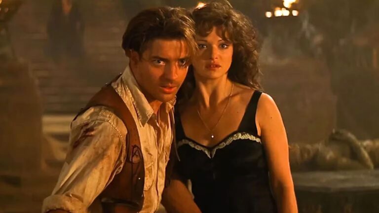 Brendan Fraser lunges for something while Rachel Weisz stays back
