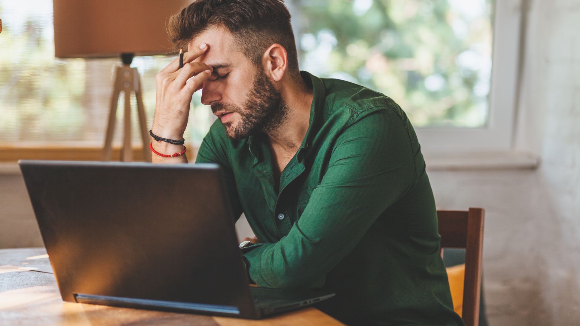 Man looking frustrated with his laptop