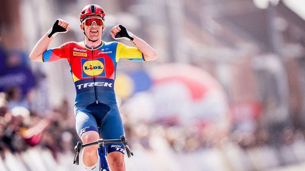 Mads Pedersen raises his hands aloft to celebrate winning the Gent-Wevelgem 2025 cycling road race.