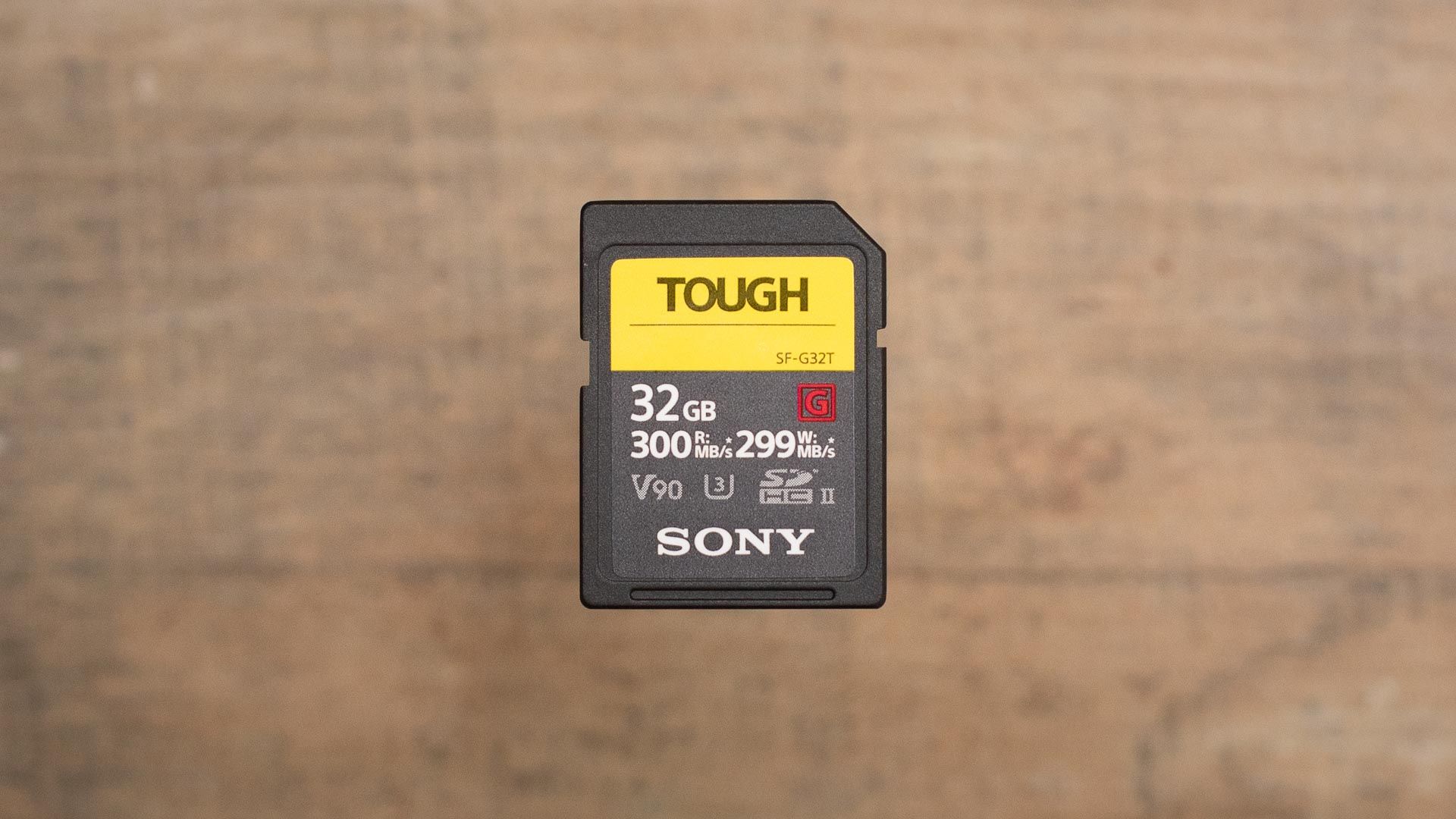 The Sony SF-G Series TOUGH UHS-II SD card on a wooden table