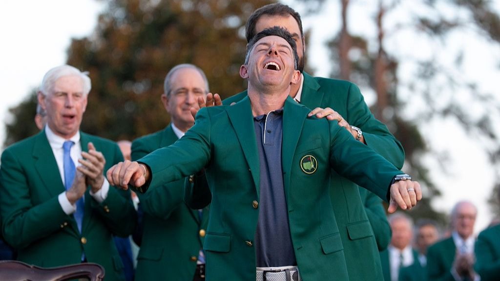 Rory McIlroy raises his head up to the sky after being presented with the Green Jacket for winning the Masters 2025