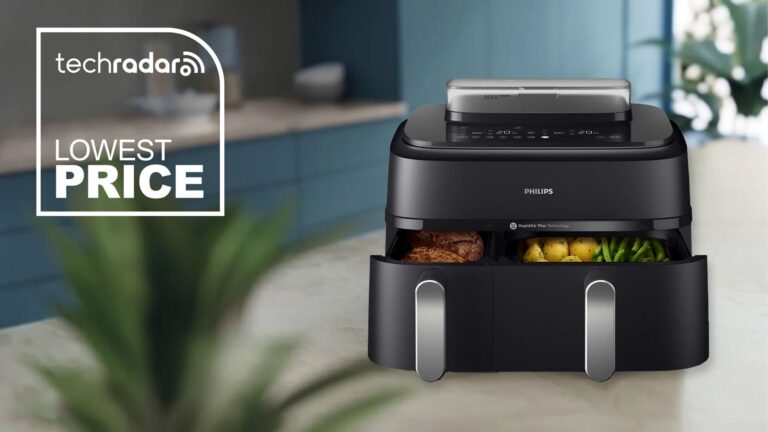 The Philips 5000 Series Dual Basket Air Fryer XXL Steam on a kitchen counter with a TechRadar deal logo for lowest price