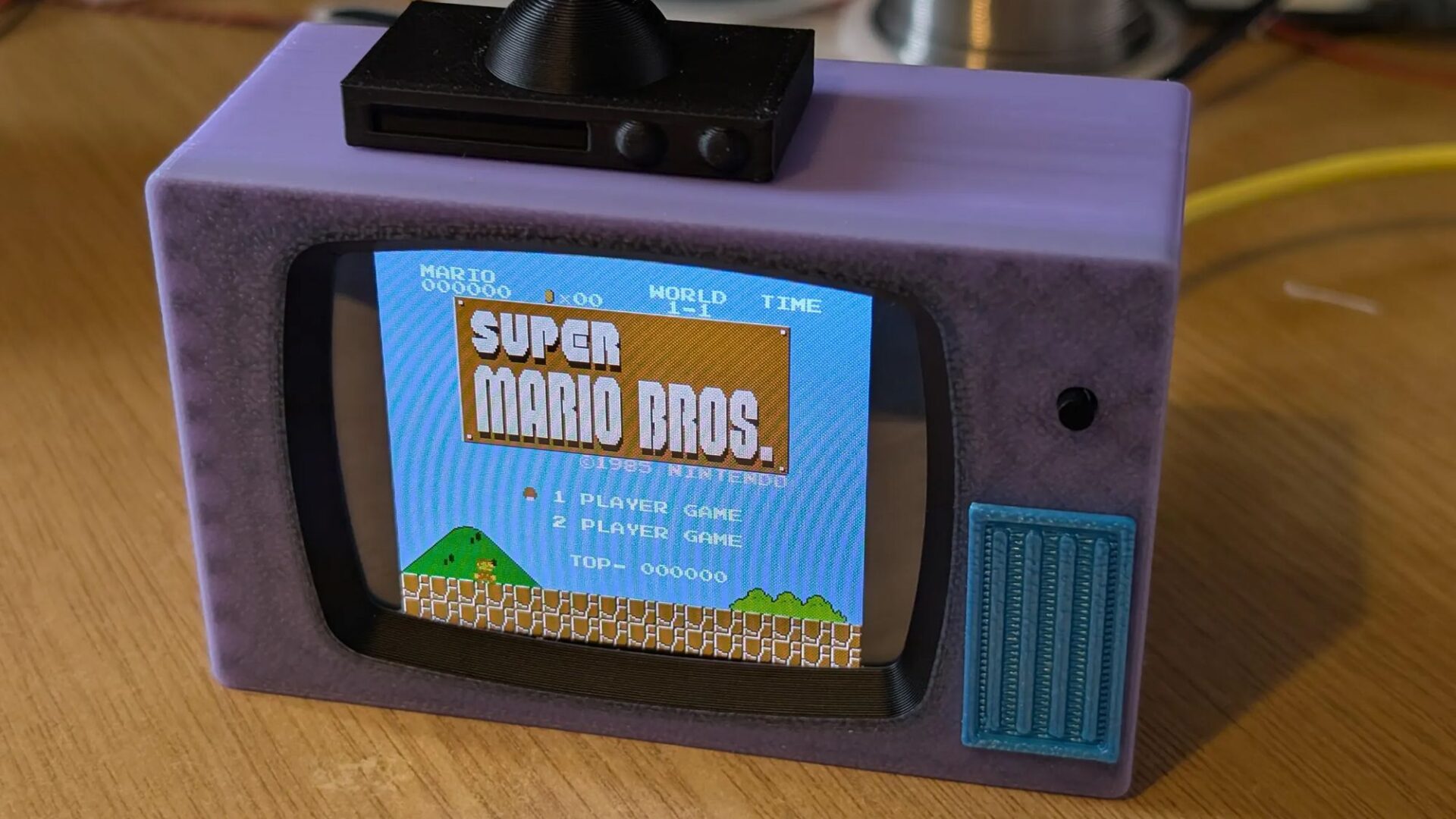 This DIY retro-style mini-TV looks like it's from the Simpsons, and plays classic NES games and movies — and yes please, I want one