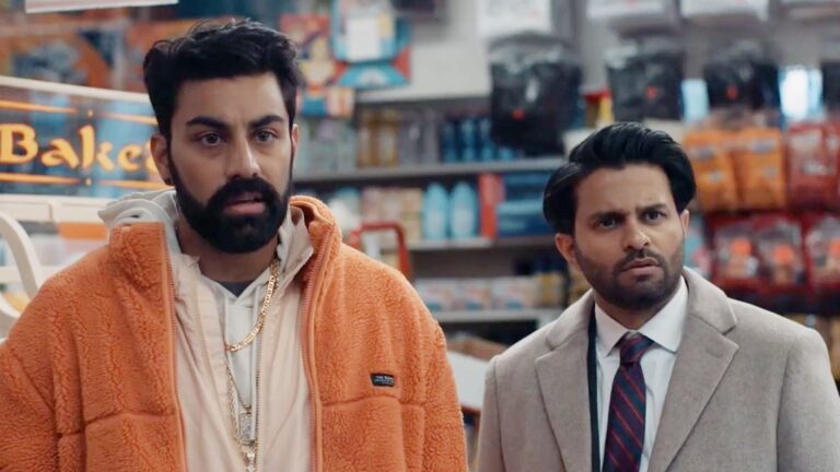 Two men stand looking confused in a convenience store