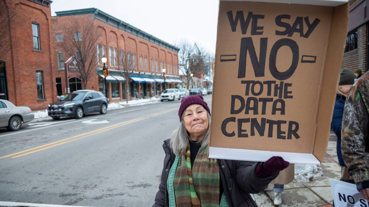 A resident holding a placard which rejects the installation of data centers