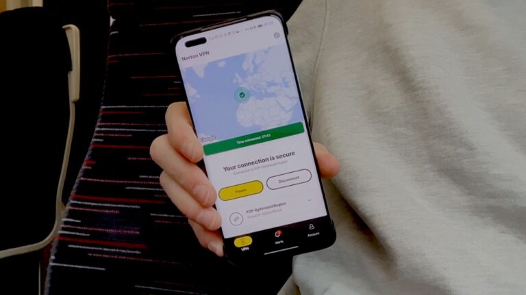 Hand holding an Android phone with the Norton VPN app running on it.