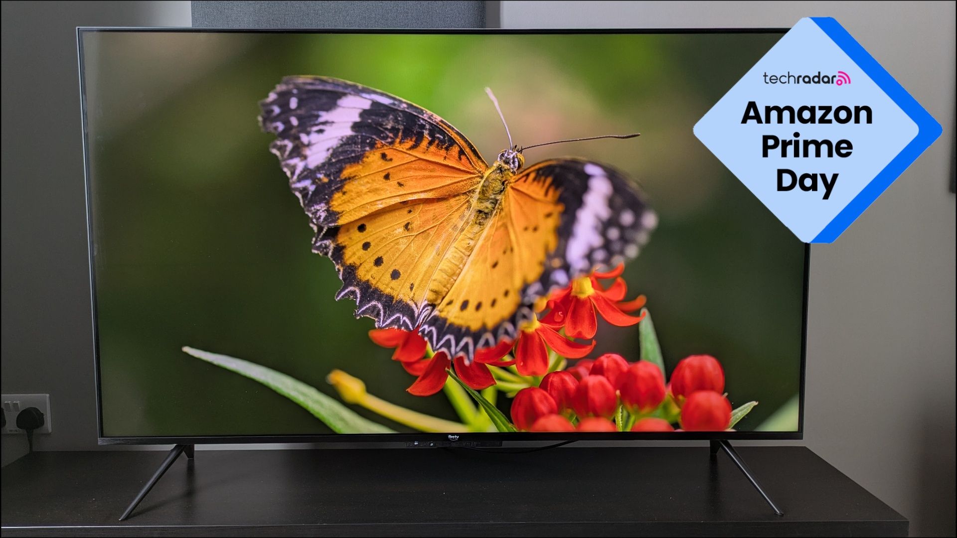 Amazon Ember Mini-LED showing orange butterfly on screen with Prime Day logo in top-left corner