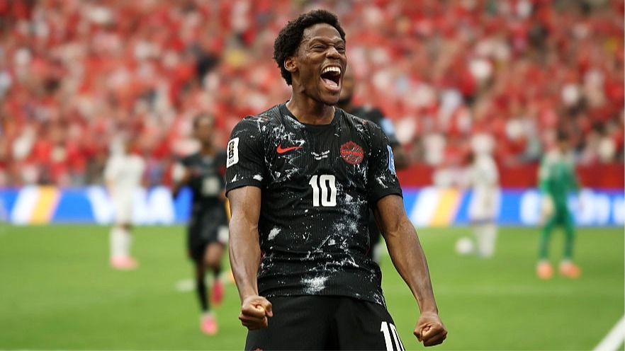 Jonathan David of Canada clenches his fists as he celebrates scoring a goal.