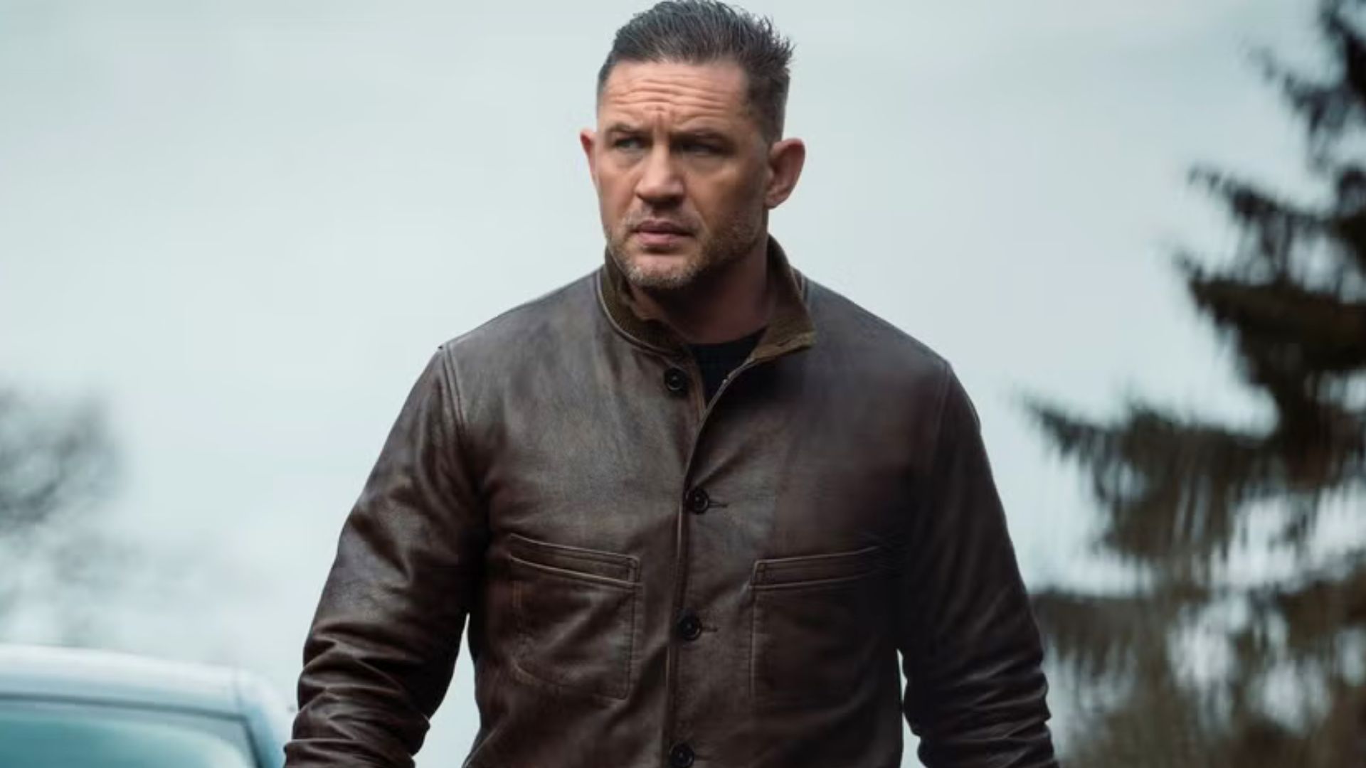 Tom Hardy looks at something in the distance