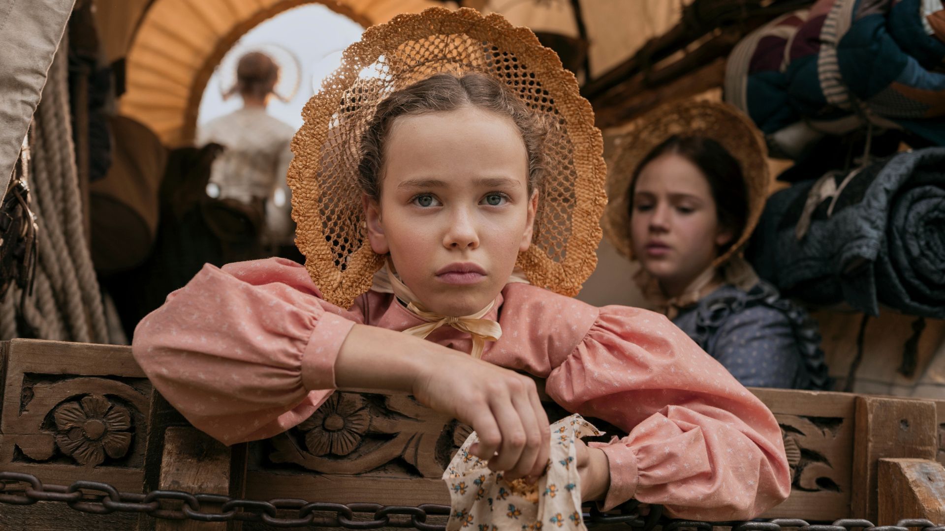 Laura Ingalls hangs out of the back of the wagon