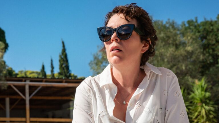 Olivia Colman sitting on a sunlounger