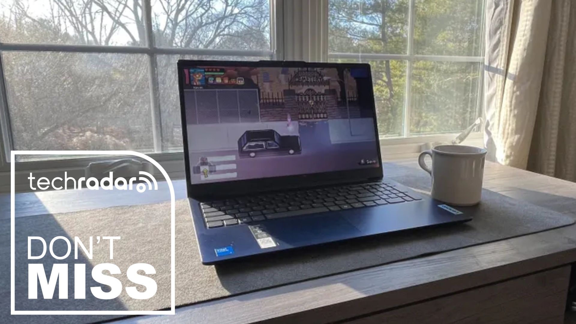 The Lenovo IdeaPad Slim 3 on a desk in a home office next to a TechRadar badge in white that reads 'Don't Miss'