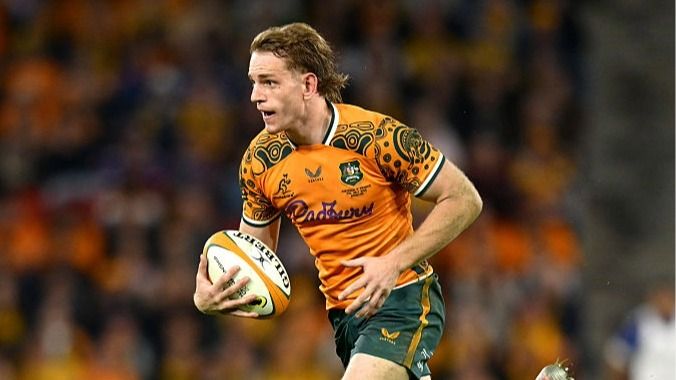 Max Jorgensen, wearing gold and green colors of Australia, runs with the rugby ball in his right hand during the Nations CHampionship 2026