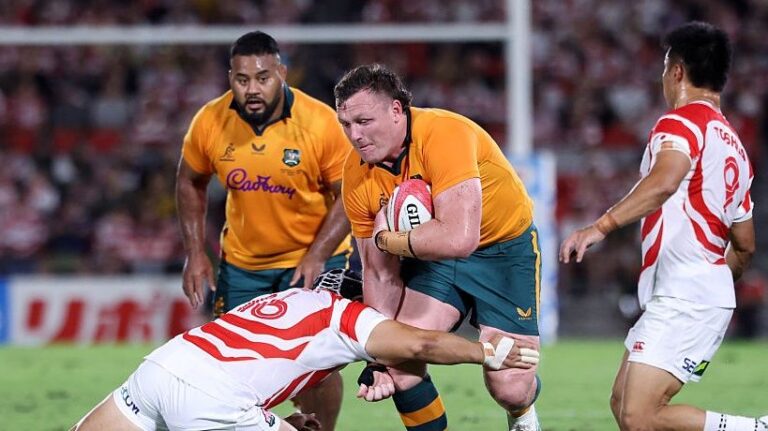 Angus Bell of Australia is tackled by Mamoru Harada of Japan during the Lipovitan D Challenge Cup between Japan and Australia. 