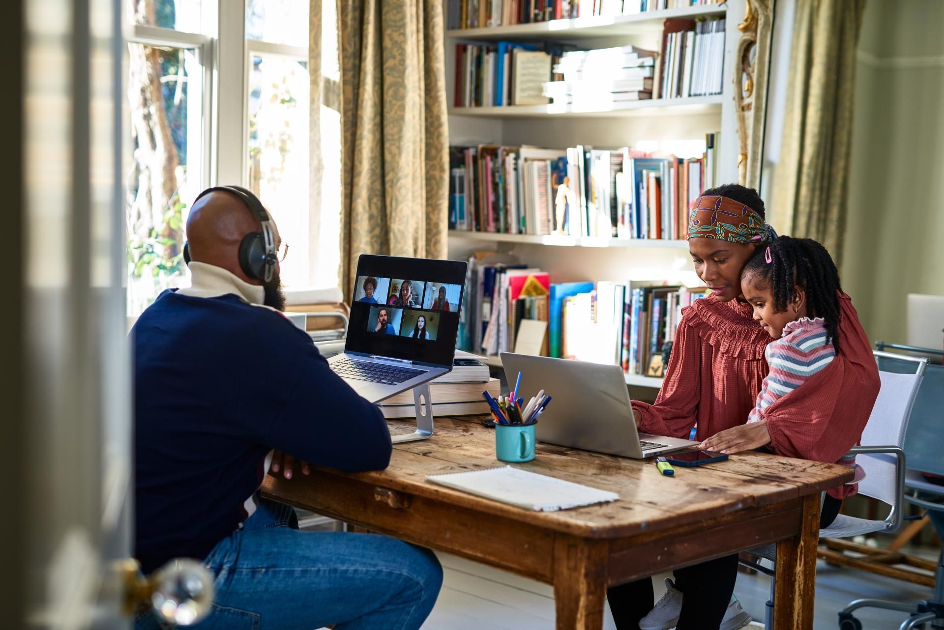 Family using laptops with EE Broadband