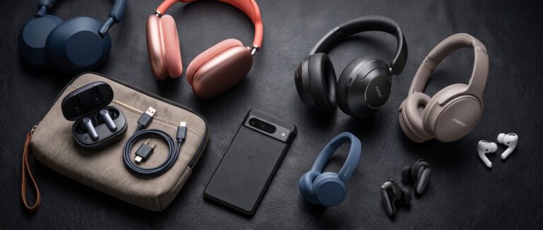 A selection of headphones and earbuds on a black desk