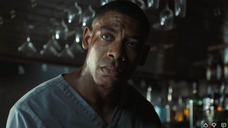 John Stewart wearing some hospital clothes and standing at a bar in Lanterns episode 5