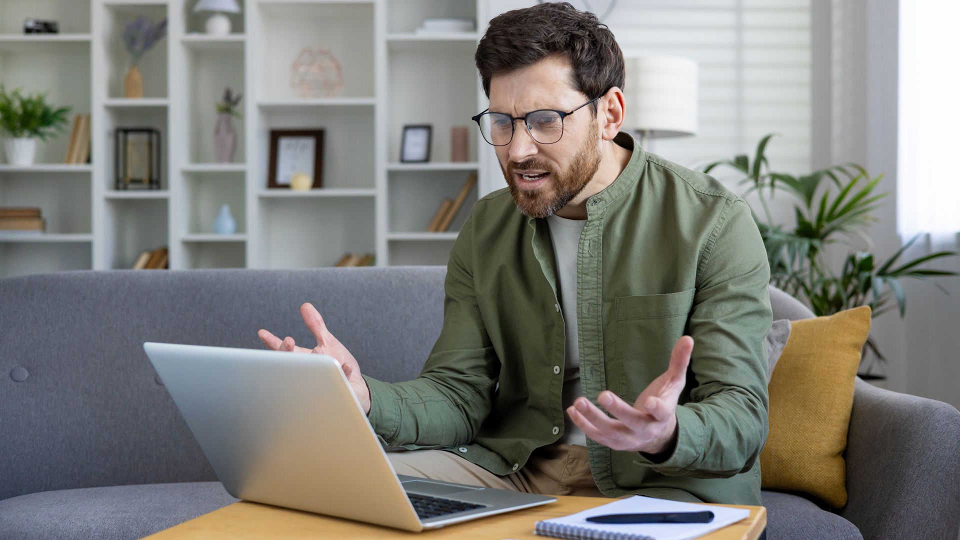 Annoyed Windows 11 user looking unhappy at their laptop