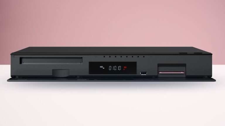 The Panasonic DMR-4X1010 Blu-ray player on a white surface with a pink background