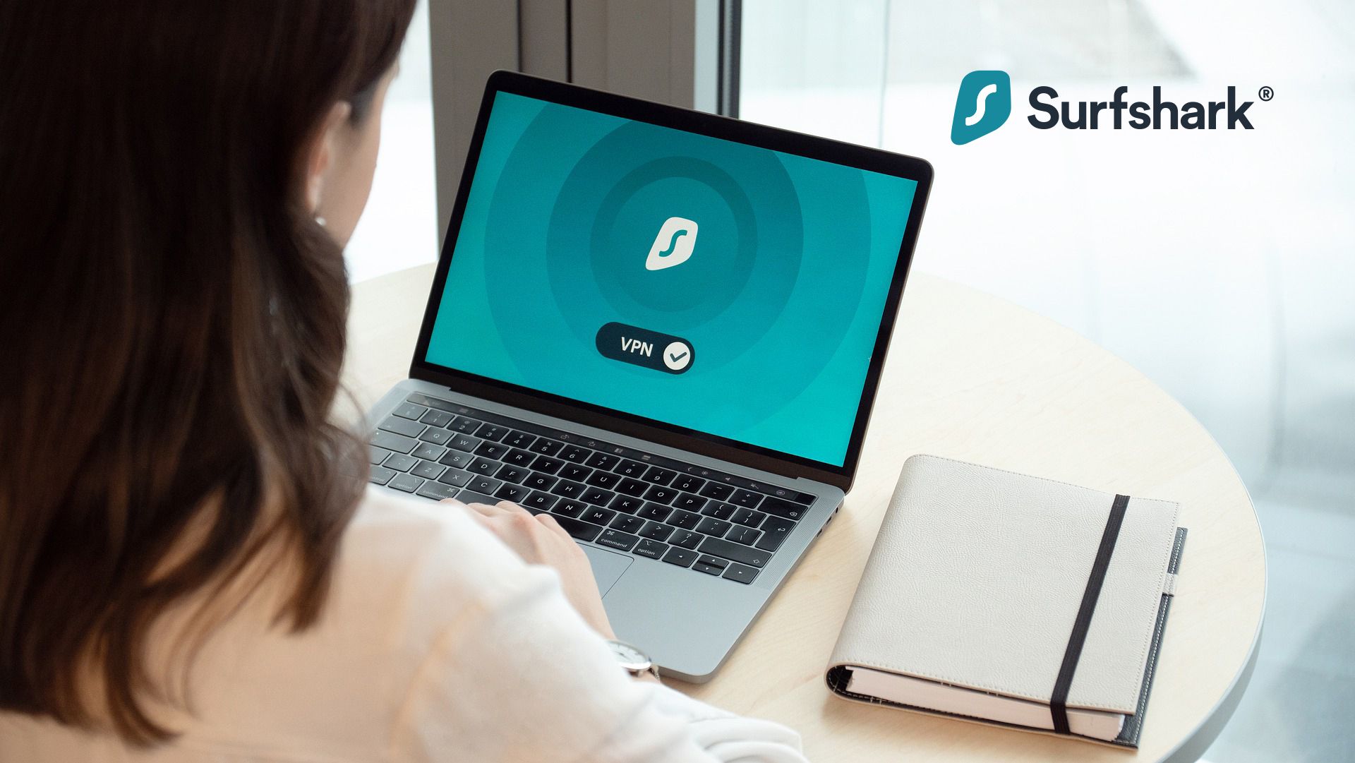 Woman using Surfshark VPN on laptop