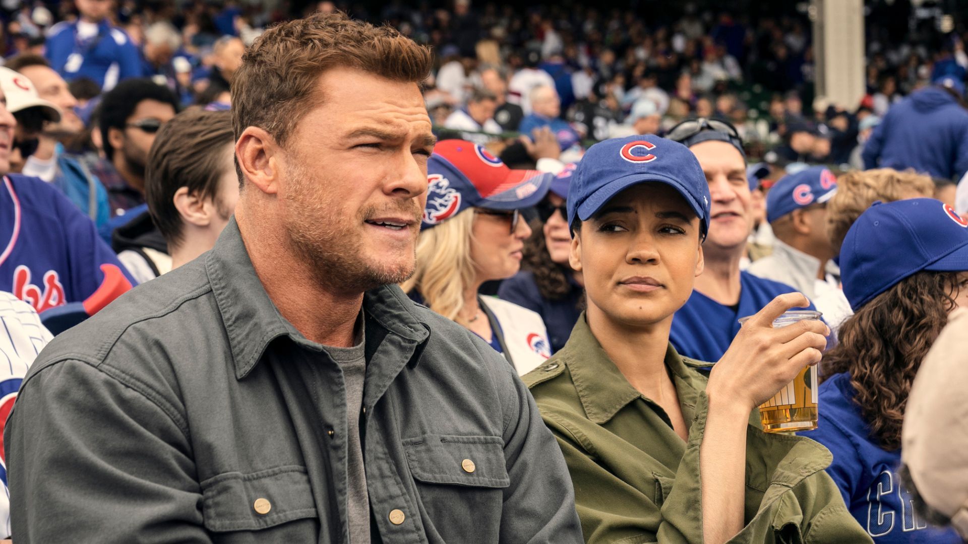 Reacher and Neagley sit in the crowd at a baseball game