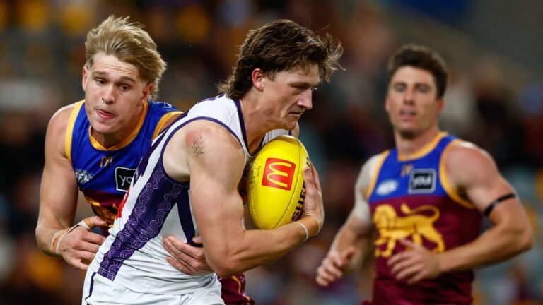 Fremantle's Jye Amiss is tackled by Brisbane's Cody Curtin during their AFL 2026 Round 12 match