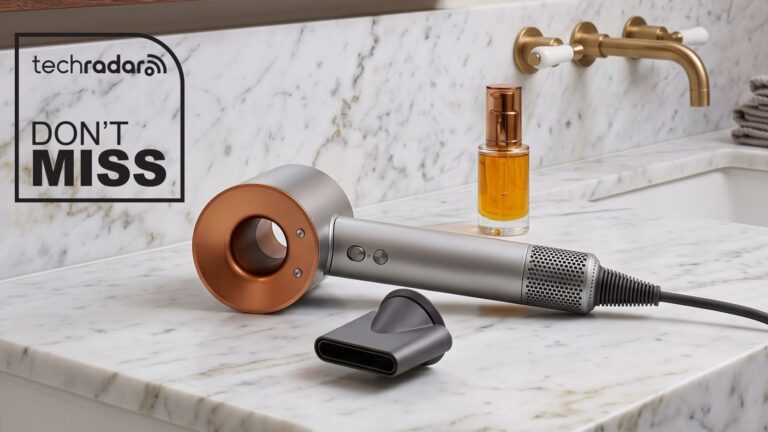 Dyson Supersonic Origin hair dryer laying flat on a marble vanity unit.